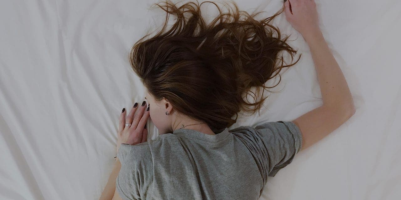 closeup half part of lady's body lying with her front body on bed