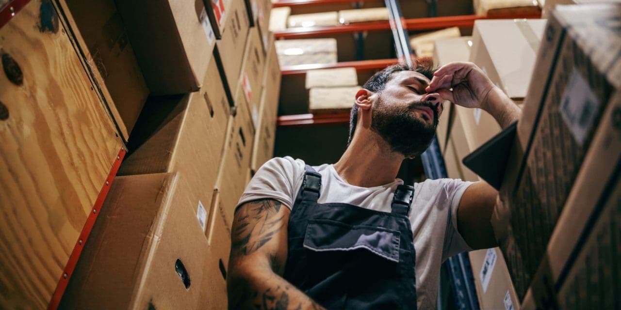 a man holding his head and nose